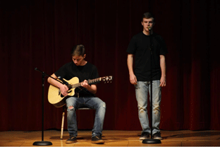 Junior Hunter Hughes sings while junior Brandon Lengefeld plays guitar at the WCHS Talent Show. The show was on March 25, 2016. 